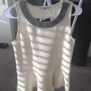 Light yellow sweetheart peplum top.